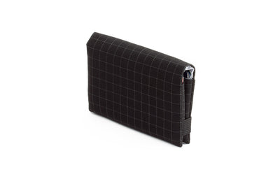 visible variant TB1275-BH^^The Size 5 Nik's Minimalist Wallet in Black (black with grey grid) 400 Halcyon closed with the attached elastic band.