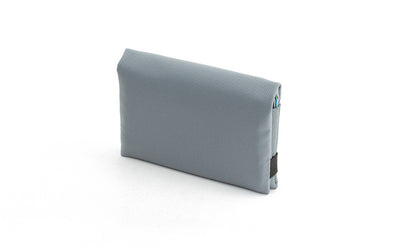 visible variant TB1275-LJ^^The Size 5 Nik's Minimalist Wallet in Cloud (light grey) 210 Ballistic closed with the attached elastic band.