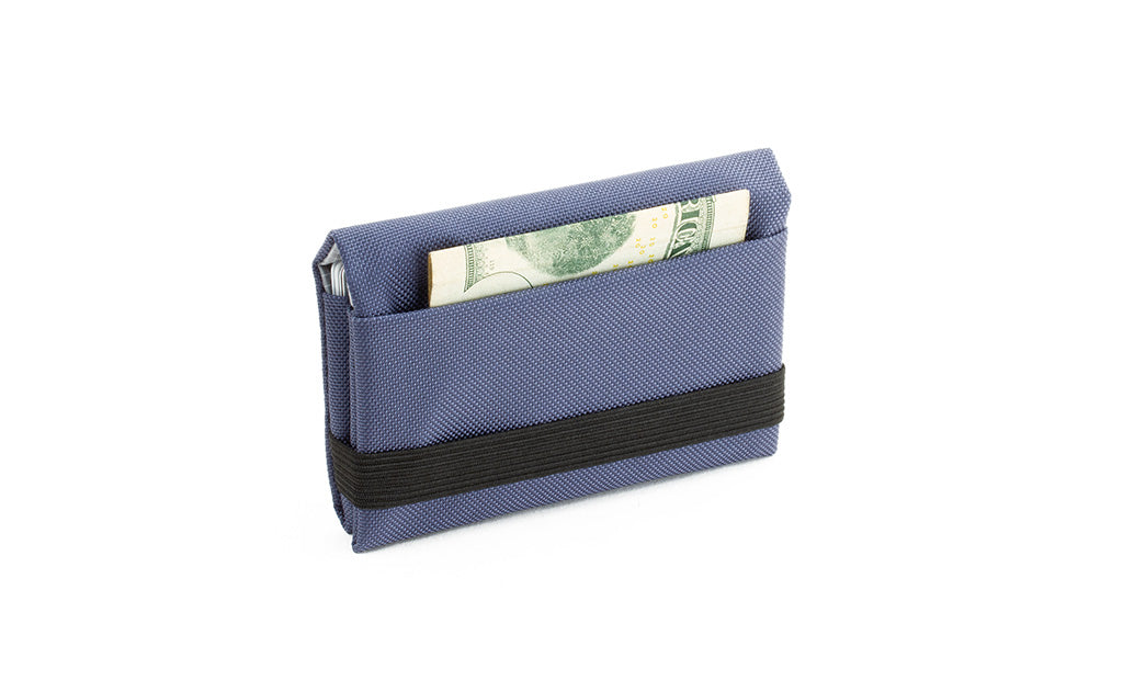 visible variant TB1275-DJ^^The Size 5 Nik's Minimalist Wallet in Dawn (blue-grey) 210 Ballistic closed with the attached elastic band.
