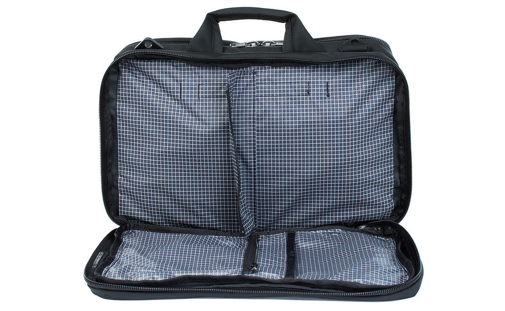 detail visible^^A front shot of the front pocket of a Black 525 Ballistic exterior open showing the Steel (dark grey) 200 Halcyon interior's zippered divider unzipped.