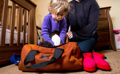 visible lifestyle ^^ A child packing a Mini Yeoman Duffel.