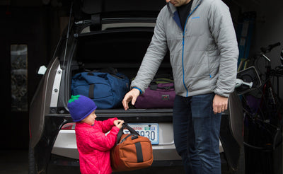 visible lifestyle ^^ A child handing a mini Yeoman to an adult to pack in a hatchback car.