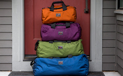 lifestyle visible ^^ The Mini, Small, and Medium Yeoman Duffels stacked on top of the Large Yeoman Duffel.