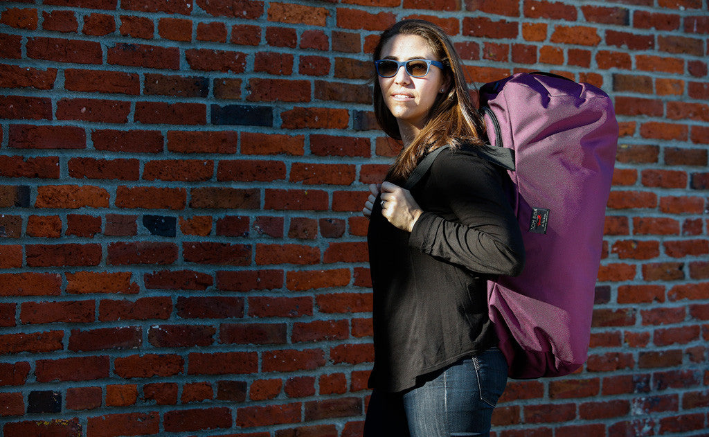 lifestyle visible^^ A person using the Large Yeoman Duffel's shoulder straps to carry it like a backpack.