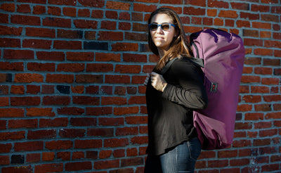 lifestyle visible^^ A person using the Large Yeoman Duffel's shoulder straps to carry it like a backpack.
