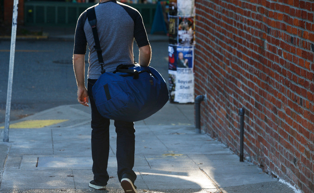 lifestyle visible^^ A person carrying a Yeoman Duffel with a shoulder strap.