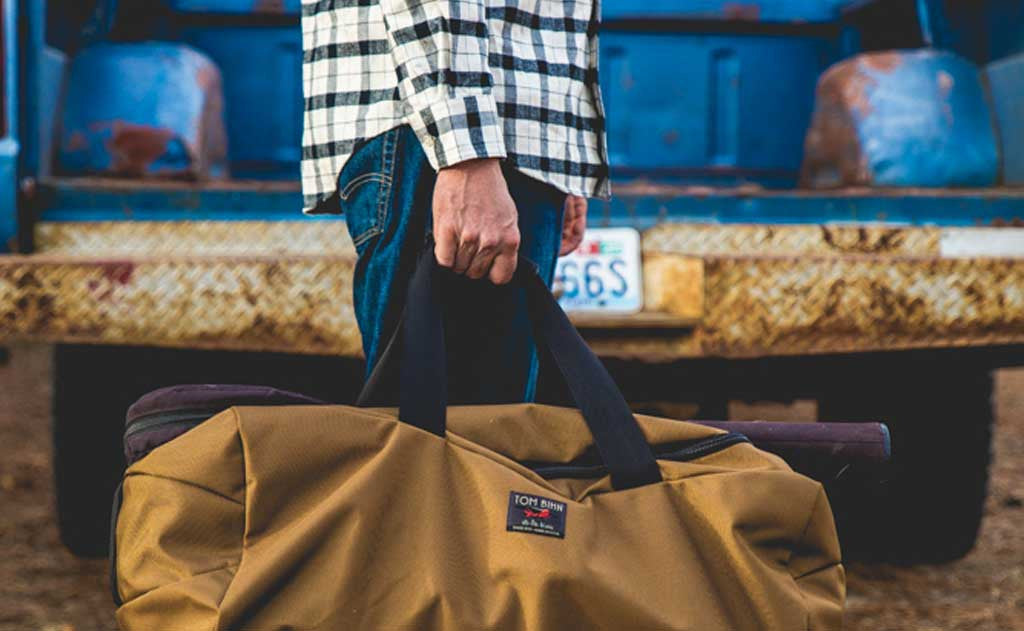 lifestyle visible ^^ A Yeoman Duffel being carried by its top grab handle.