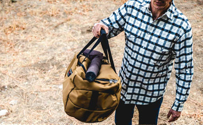 lifestyle visible ^^ A person carrying the Yeoman Duffel by its top grab handle.