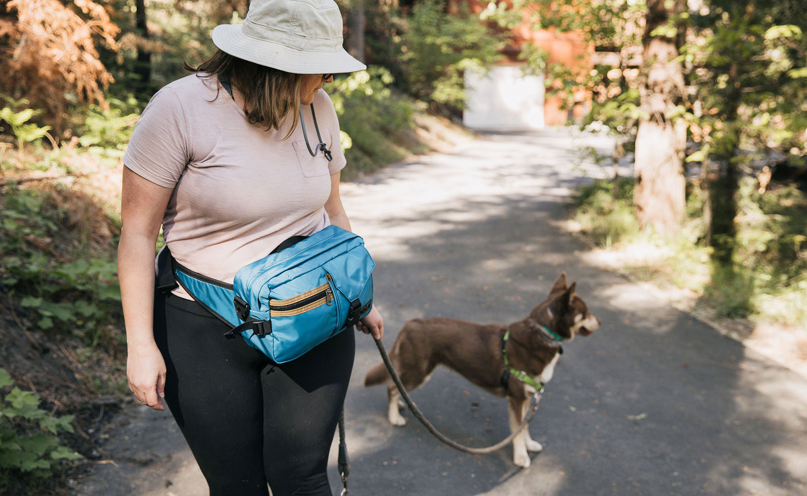 lifestyle visible^^Person walking their dog wearing the LGD as a waist pack, on the front.