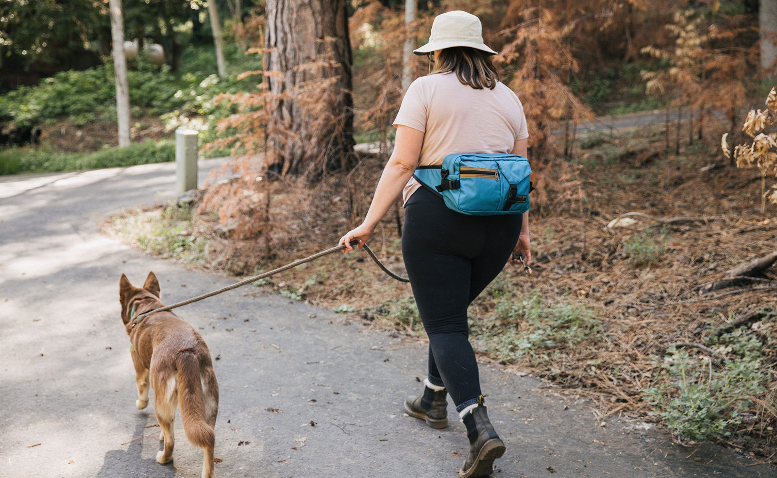 lifestyle visible^^Person walking their dog wearing the LGD as a waist pack.