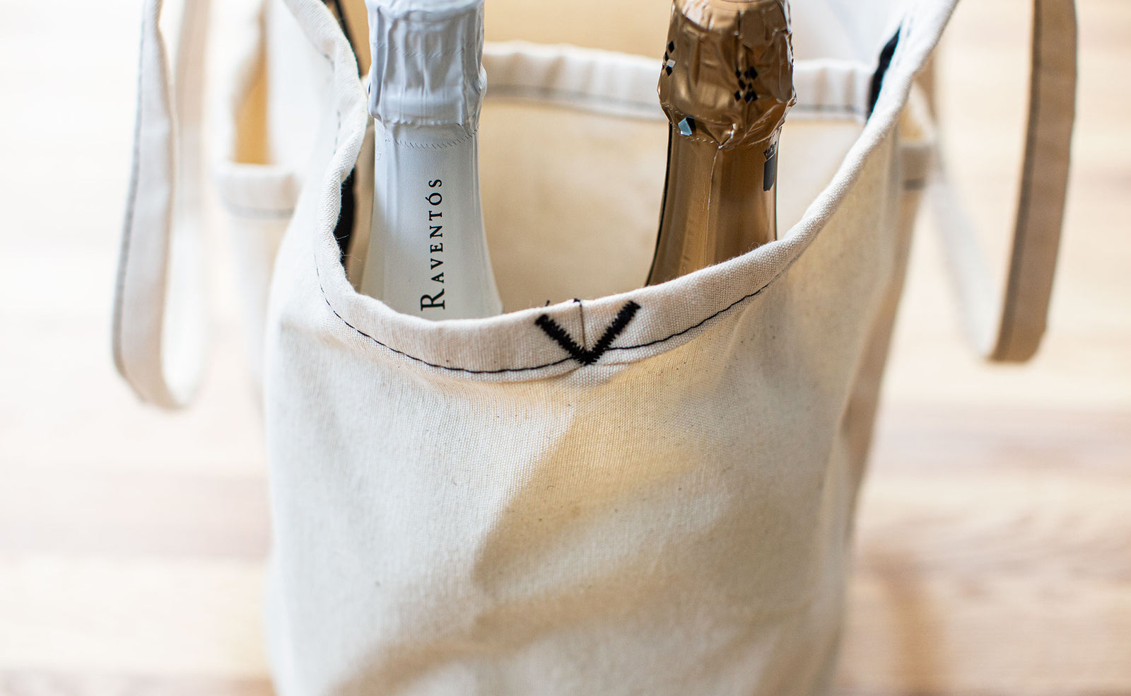 lifestyle visible^^Two bottles of sparkling wine in the end pocket of a Natural Organic Cotton Truck.