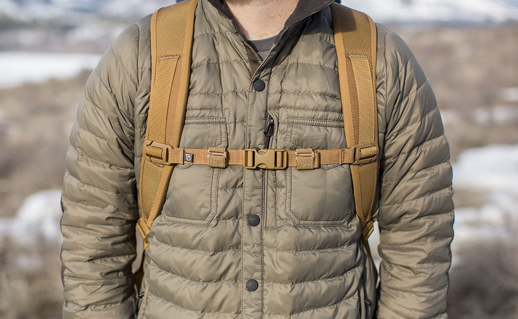 lifestyle visible^^A Coyote (brown) Strap Keeper holding a sternum strap excess strap in place.