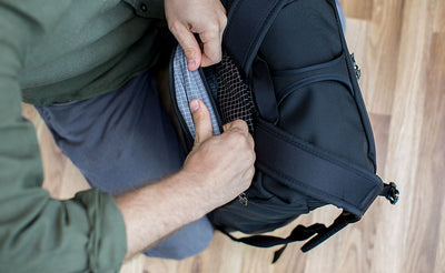 lifestyle visible^^A top-down view of inserting an Aeronaut 45 Frame Sheet into the bottom/rear pocket of the Aeronaut 45.
