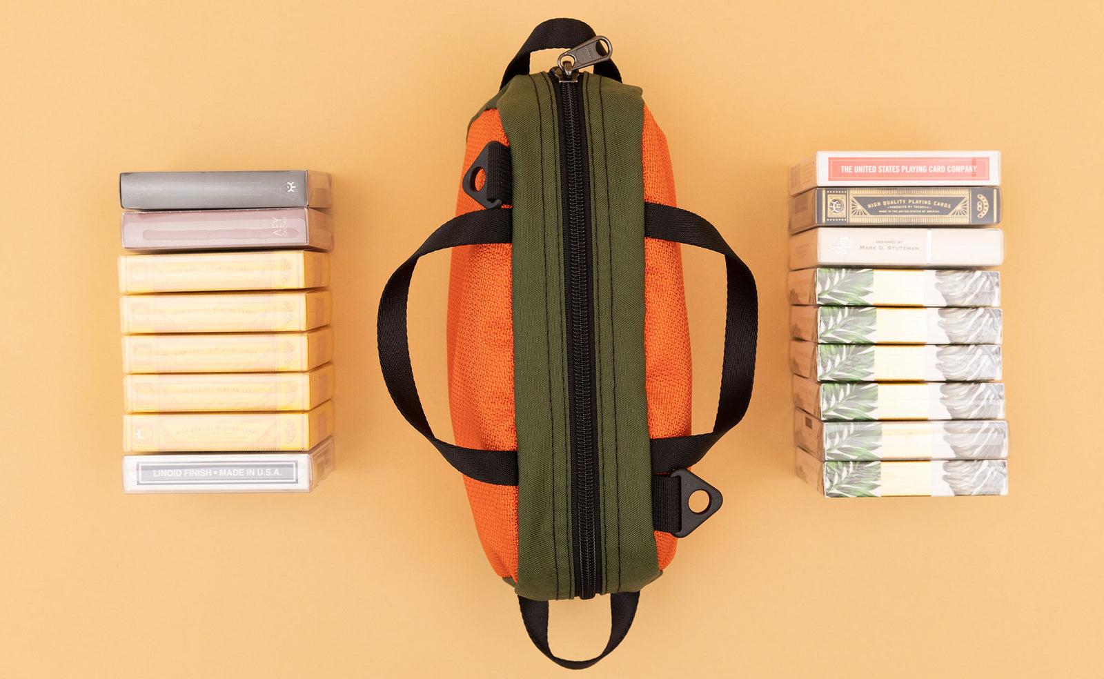 detail visible^^ A Texturized Orange Grab Bag with 17 decks of cards on either side. 