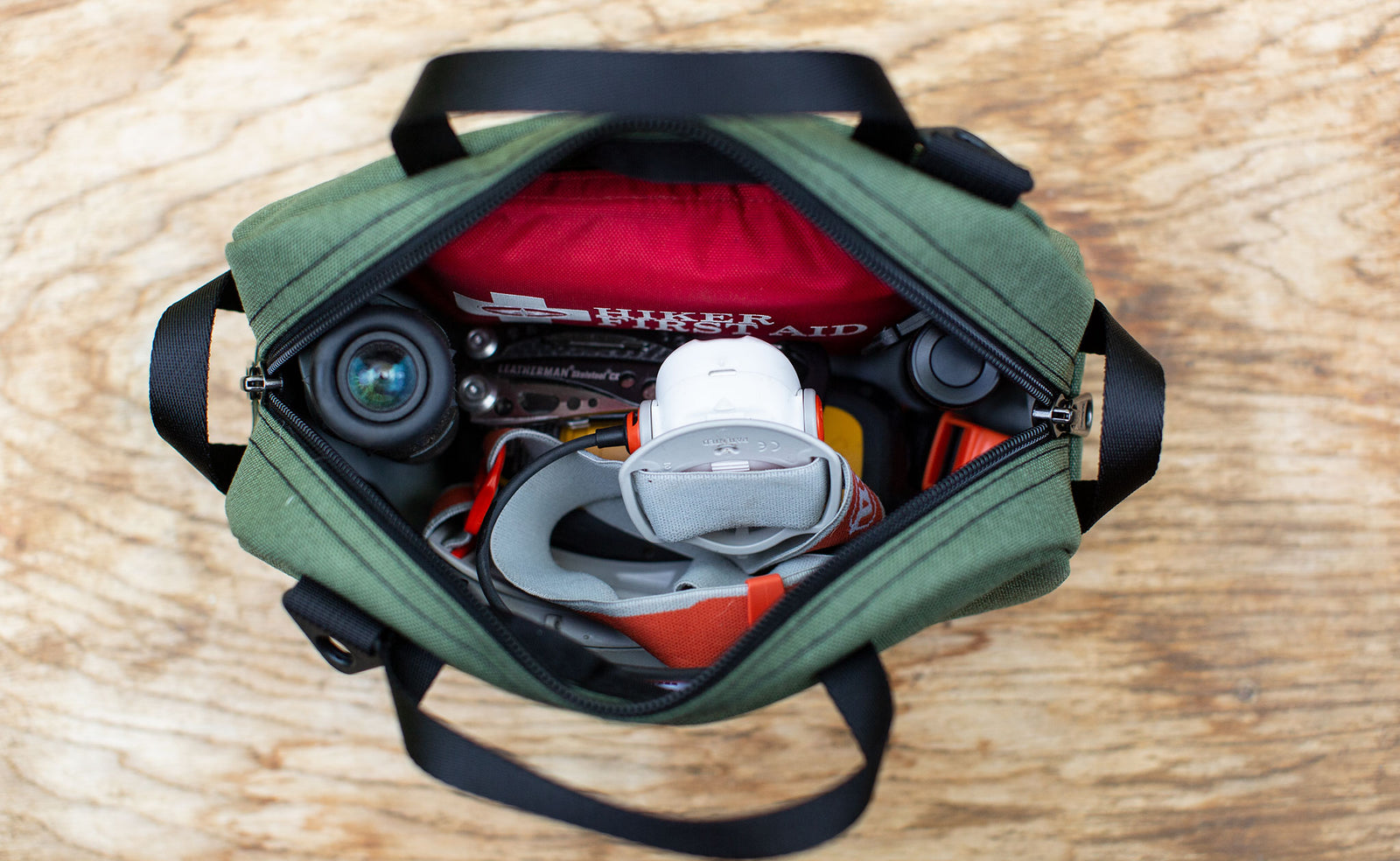 detail visible^^ a Boreal Grab Bag filled with camping items including a headlamp, a flashlight, and a First Aid Kit. 