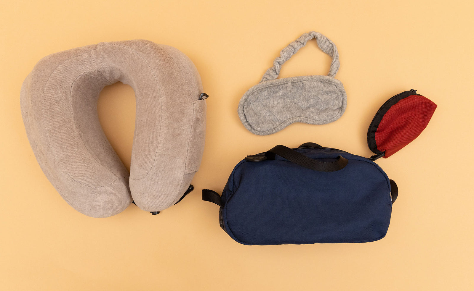 detail visible^^ A Navy Parapack Grab Bag with travel sleep accessories next to it including a Small Mars Red Q-Kit. 