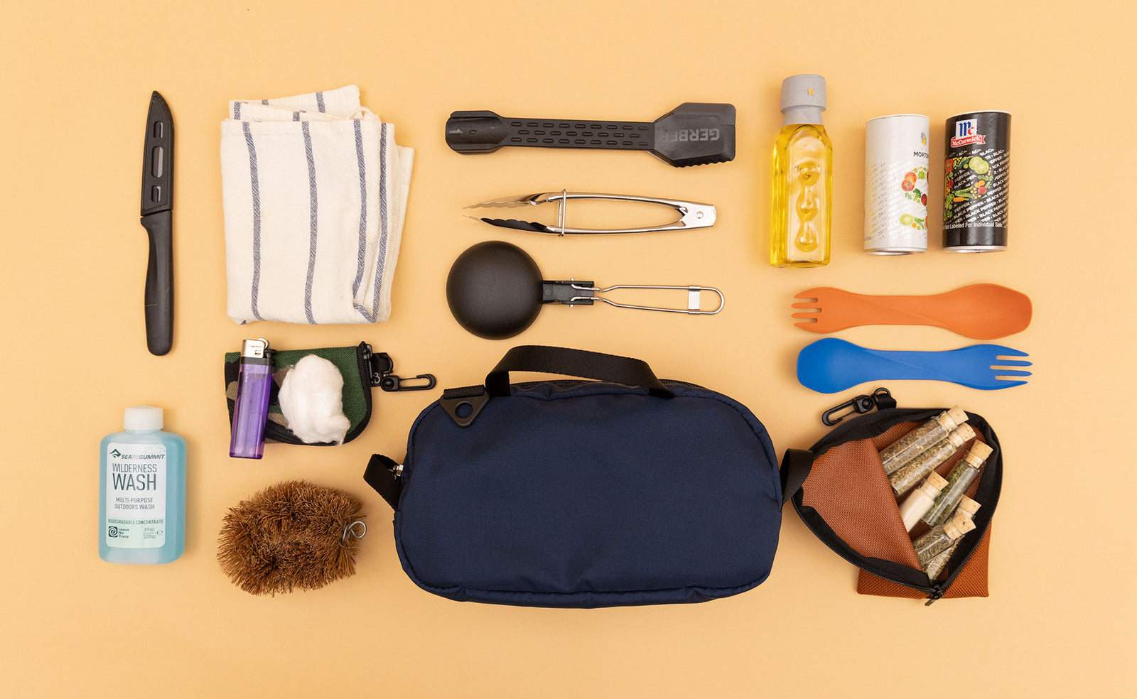 detail visible^^ A Navy Parapack Grab Bag with items used for camp cooking next to it. 