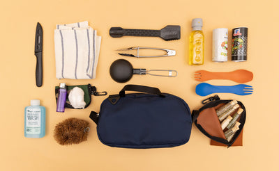 detail visible^^ A Navy Parapack Grab Bag with items used for camp cooking next to it. 