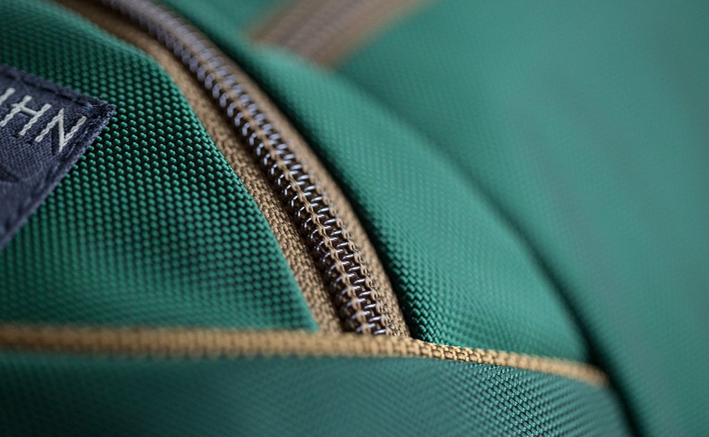 detail visible^^A close shot of the Coyote (brown) zipper and trim of the Guide's Edition Synik 22.