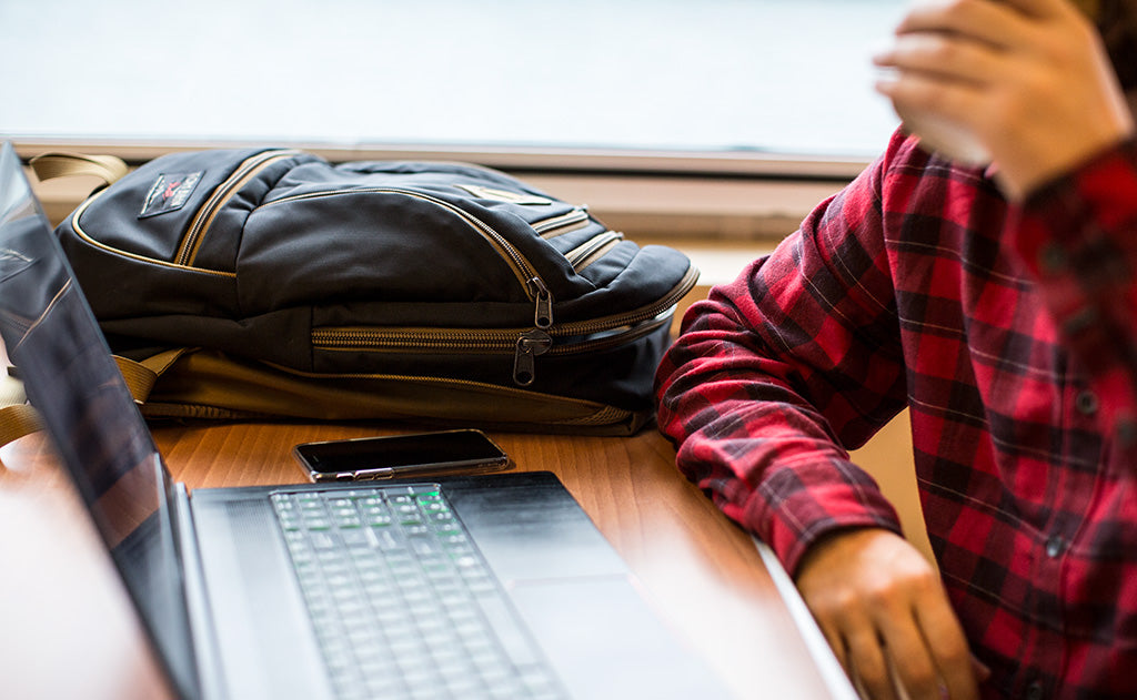 lifestyle visible^^A person at a table in a ferry with the Guide's Edition Synapse 25.