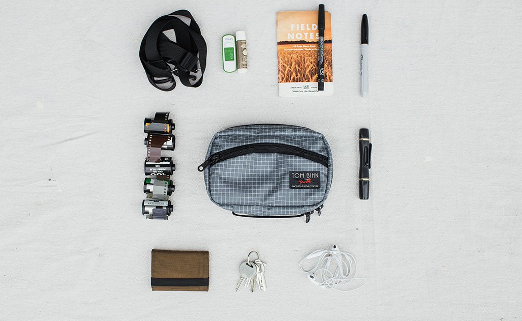 visible lifestyle ^^ A potential load out of the HLT1, including a wallet, keys, earbuds, a mini flashlight, pens, a small notebook, and rolls of film.