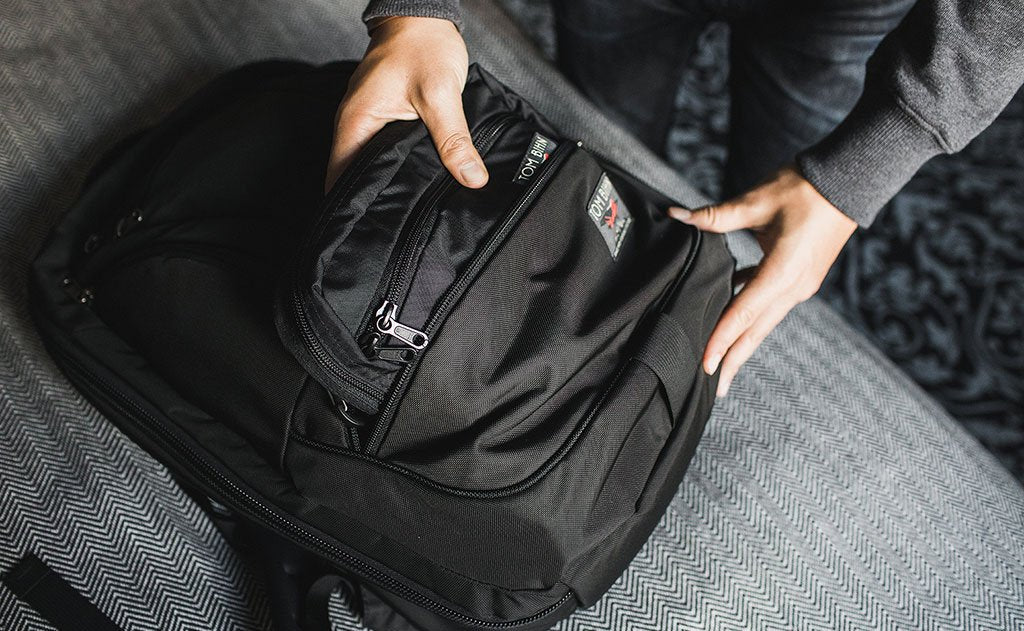 lifestyle ^^ A person putting an HLT2 in the front bottom pocket of a Synik 30.