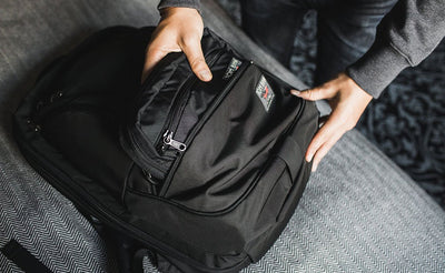 lifestyle ^^ A person putting an HLT2 in the front bottom pocket of a Synik 30.