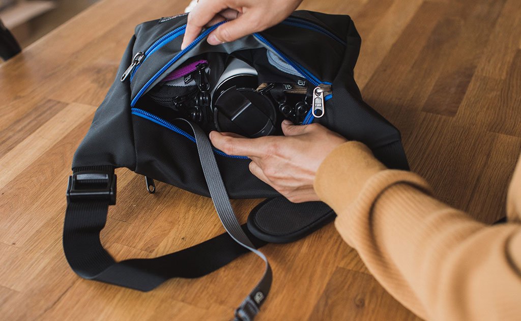 detail visible^^A person retrieving a camera from the main compartment of the Icon.