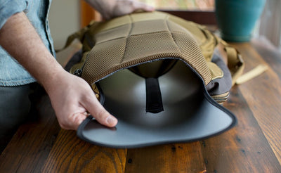 detail visible^^A person removing the Guide's Edition Synik 22's removeable frame sheet.