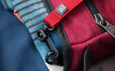 visible^^A close shot of a the snaphook of a Key Strap attached to the o-ring in a Small Cafe Bag.