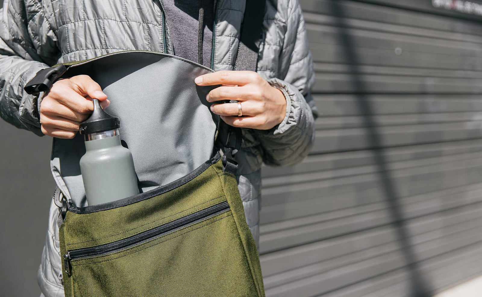 lifestyle visible^^Person pulling a water bottle out of the Large Cafe Bag.