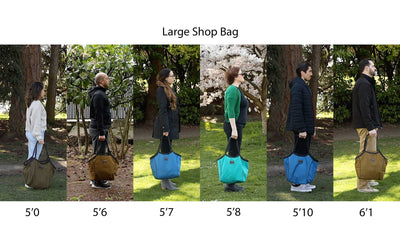 lifestyle visible^^People of different heights standing side-by-side holding Large Shop Bags.