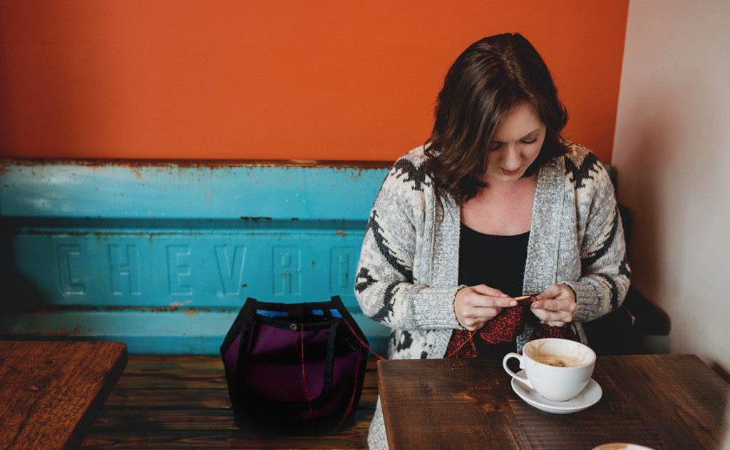 lifestyle visible^^A person knitting out of the Little Swift in a cafe.
