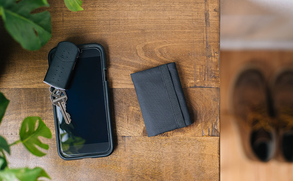 detail visible^^A Nik's Minimalist Wallet next to a phone and key fob.