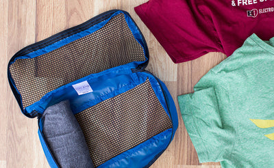 ^^Rolled shirts placed into a Small Western Flyer Packing Cube in Island (blue) 120 Aether.