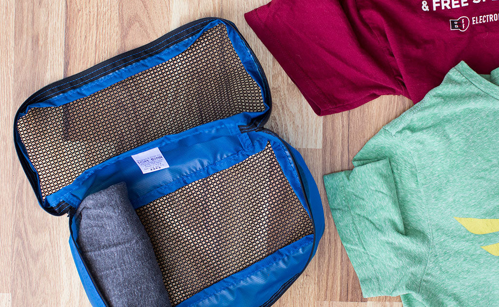 lifestyle visible ^^3 or 4 rolled t-shirts fit well in a Small Aeronaut 30 Packing Cube.