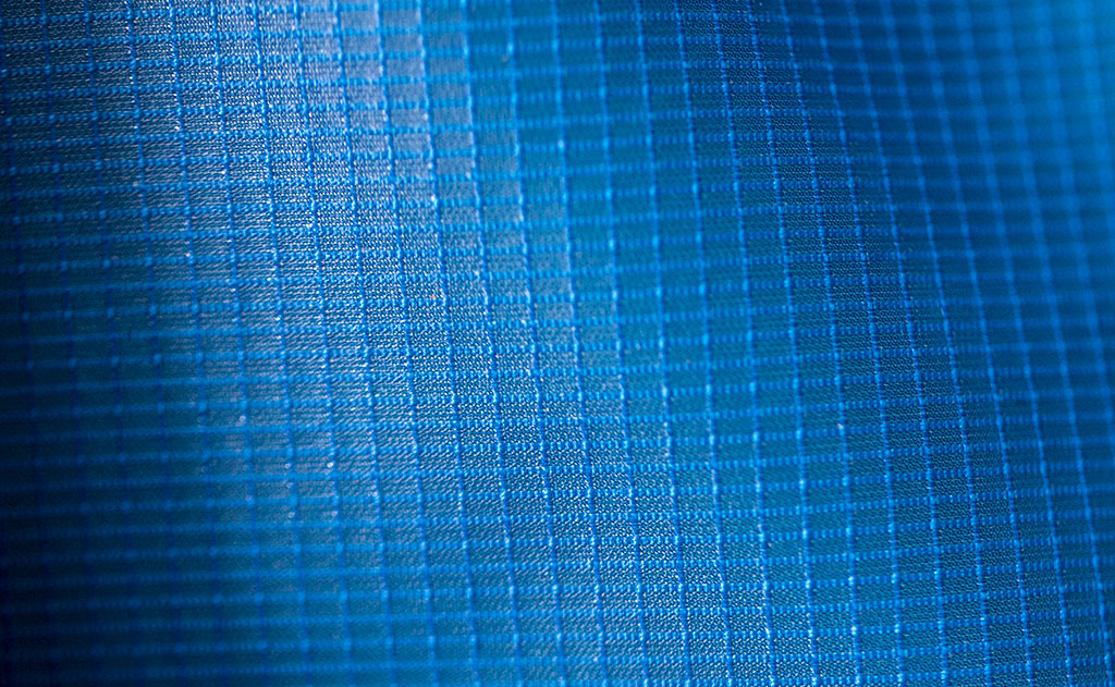 lifestyle visible^^Aether 120 is a rip-stop fabric with tiny white lines forming a subtle check pattern.