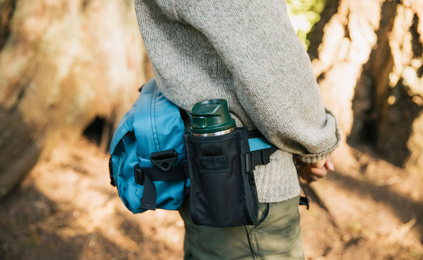 lifestyle visible^^Person wearing the LGD waist pack with the Padded Hip Belt Pocket: in it is a water bottle.