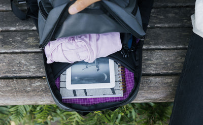visible lifestyle^^A filled Paradigm with a notepad, eReader, and a hoodie visible in the main pocket.