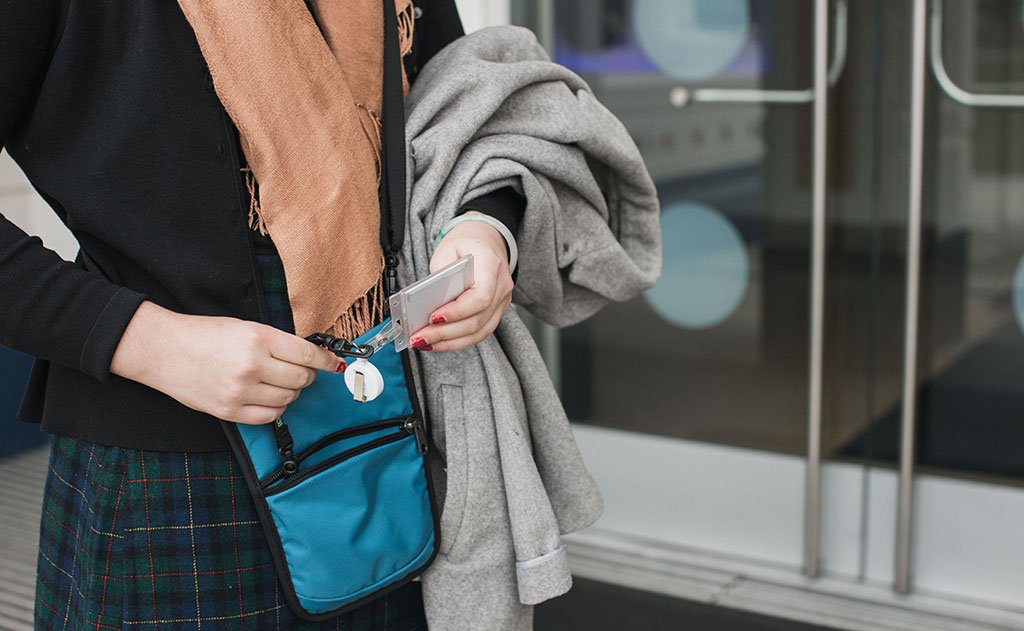 lifestyle visible^^A person accessing a scan card in the front pocket of the  P.I.K.A. Pouch.