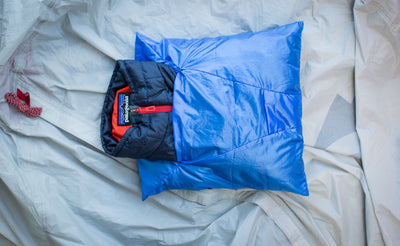 detail visible^^A Pocket Travel Pillow stuffed with a padded jacket.