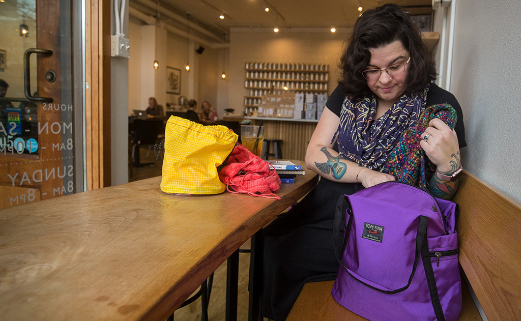 lifestyle visible^^A person accessing the main compartment of the Pop Tote.