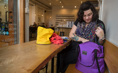 lifestyle visible^^A person accessing the main compartment of the Pop Tote.