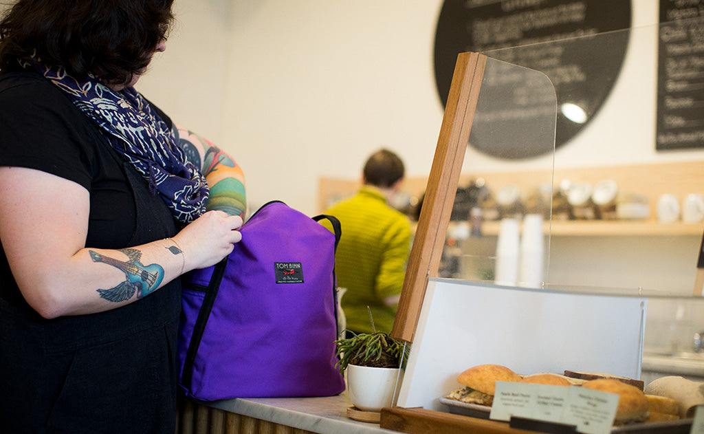 lifestyle visible^^A person accessing the main compartment of the Pop Tote.