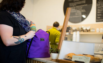 lifestyle visible^^A person accessing the main compartment of the Pop Tote.