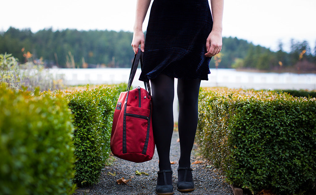 lifestyle visible^^A person carrying the Pop Tote via the padded carry handles.