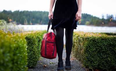 lifestyle visible^^A person carrying the Pop Tote via the padded carry handles.