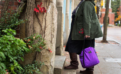 lifestyle visible^^A person carrying the Pop Tote via the padded carry handles.