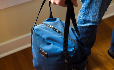lifestyle visible^^A Pop Tote being carried by the padded carry handles.