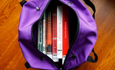 lifestyle visible^^A Pop Tote filled with books.